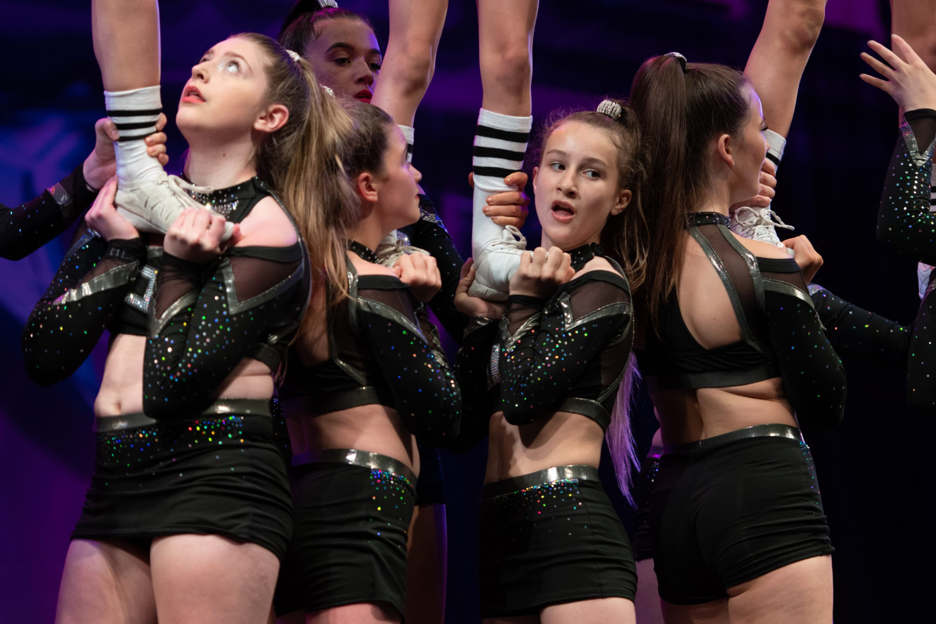 Future Cheer athletes mid-stunt at a competition